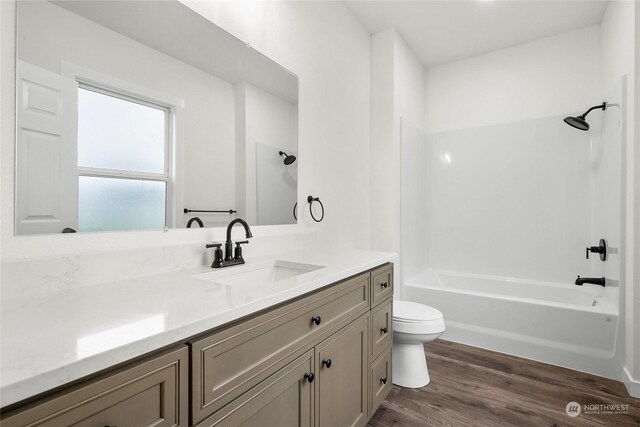 full bathroom featuring wood-type flooring, vanity, toilet, and shower / bathtub combination