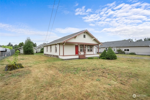 rear view of property with a lawn