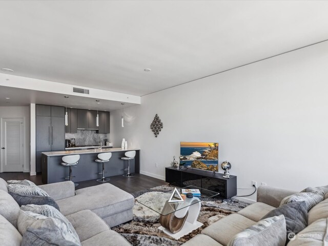 living room featuring dark wood-type flooring