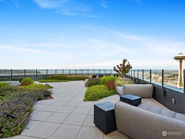 view of patio with an outdoor living space and a water view