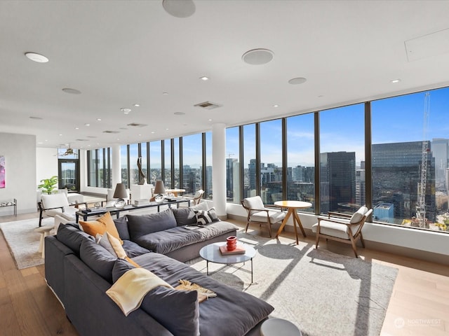 living area featuring a view of city, wood finished floors, and visible vents