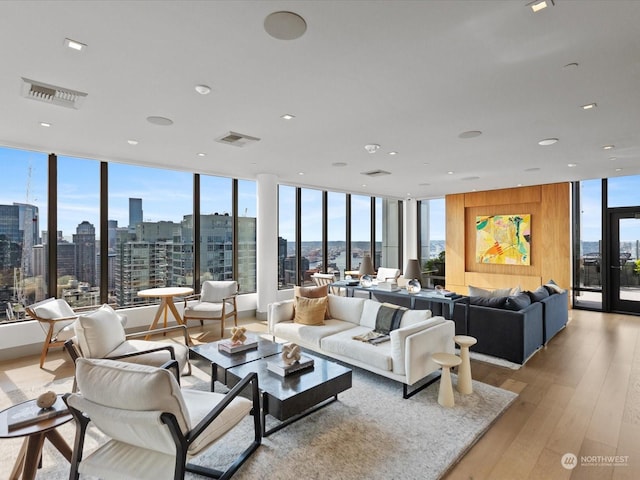 living room featuring a view of city, visible vents, and light wood finished floors