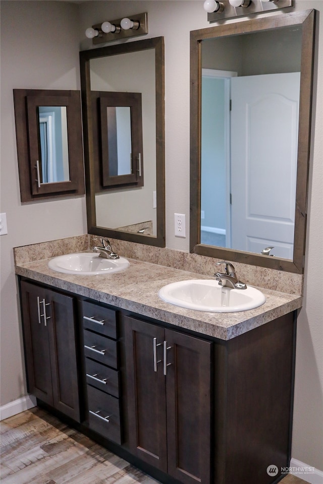 bathroom with vanity and hardwood / wood-style flooring