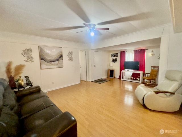 living room with ceiling fan, crown molding, and wood-type flooring