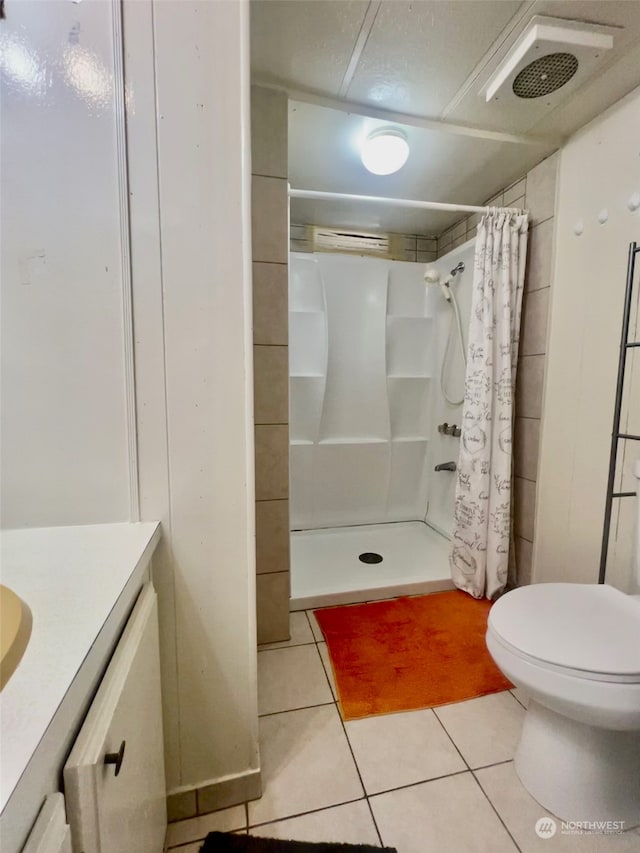 bathroom with tile patterned flooring, toilet, vanity, and a shower with shower curtain