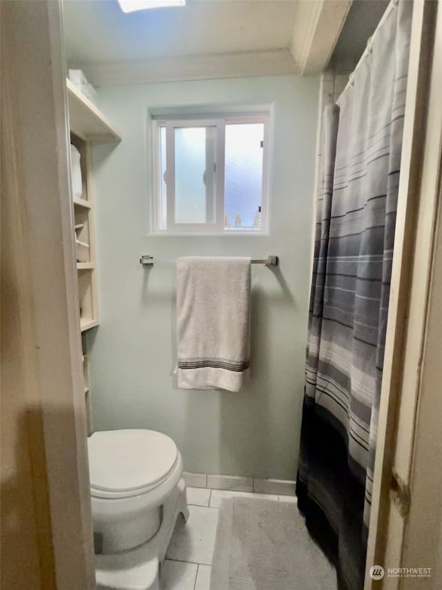 bathroom featuring crown molding, toilet, and tile patterned flooring