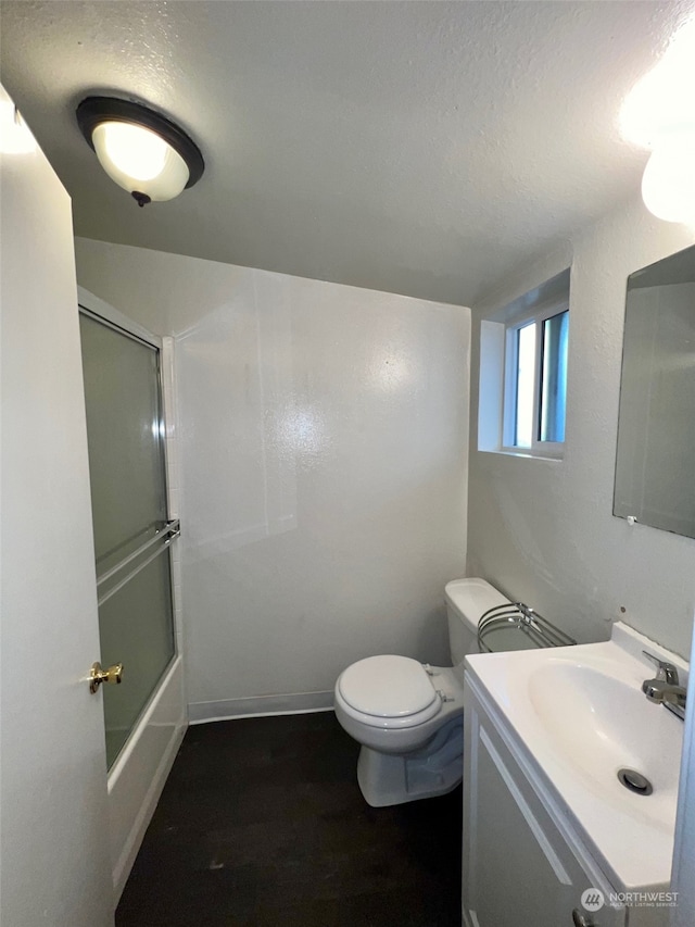 bathroom with a textured ceiling, toilet, hardwood / wood-style floors, and vanity