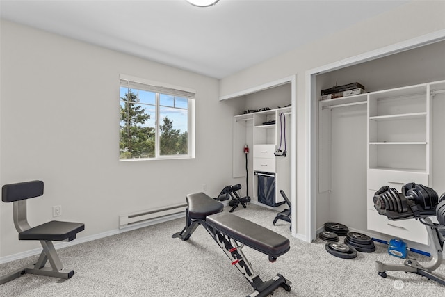 exercise room with carpet flooring and a baseboard heating unit