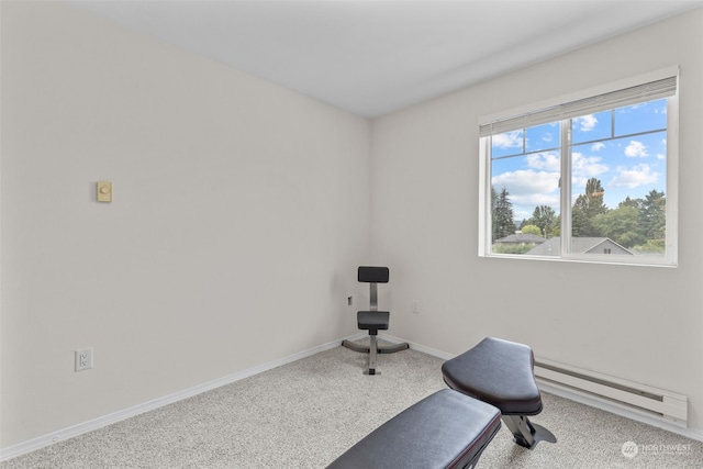 exercise room with carpet and baseboard heating