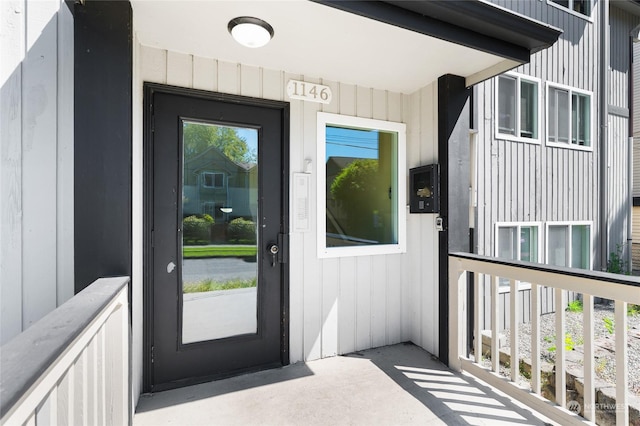 view of exterior entry featuring board and batten siding