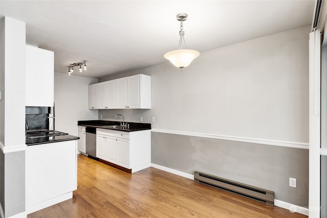 kitchen with decorative light fixtures, light hardwood / wood-style floors, stainless steel dishwasher, rail lighting, and a baseboard radiator