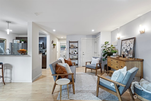 sitting room with sink and light hardwood / wood-style flooring