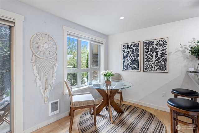 dining area with light wood-type flooring and plenty of natural light