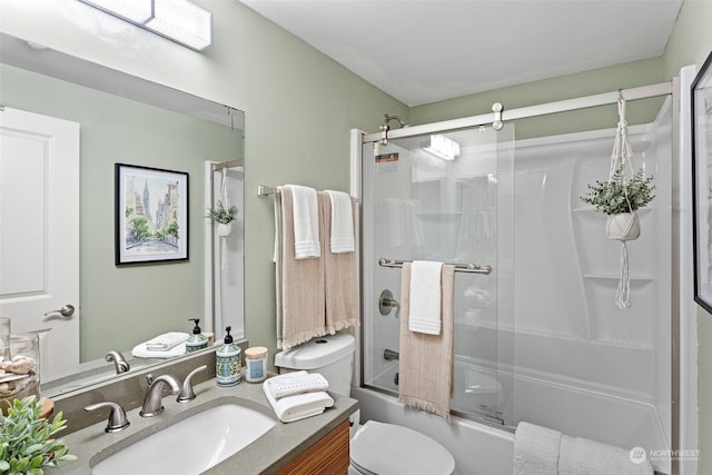 full bathroom featuring combined bath / shower with glass door, toilet, and vanity