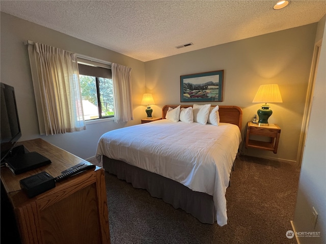 carpeted bedroom featuring a textured ceiling