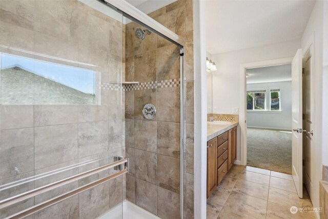 bathroom featuring a tile shower and vanity