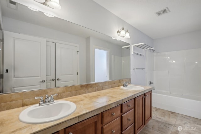 full bath featuring double vanity, visible vents, shower / washtub combination, and a sink