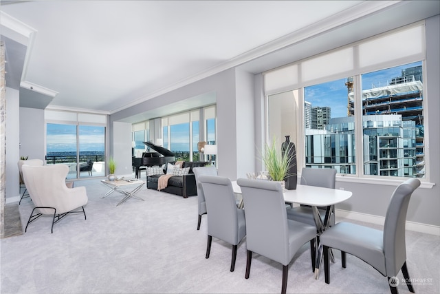 carpeted dining area featuring crown molding