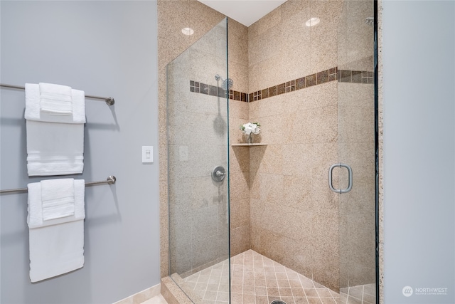 bathroom with a shower with door