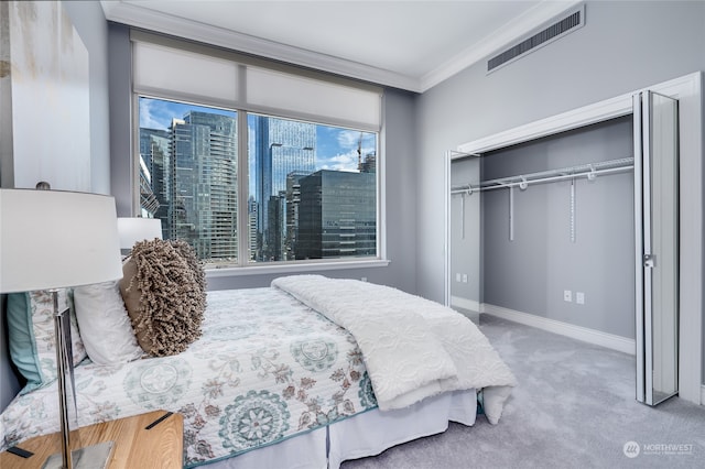 bedroom featuring carpet floors, crown molding, a closet, and multiple windows