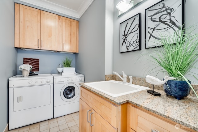 laundry area featuring sink, washing machine and clothes dryer, light tile patterned flooring, and ornamental molding