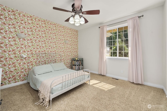 bedroom featuring ceiling fan and light carpet