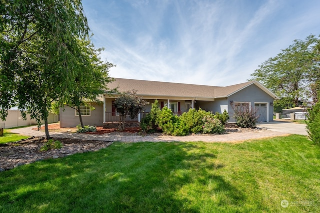 ranch-style home with a garage and a front lawn