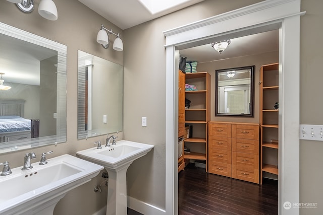 bathroom with hardwood / wood-style flooring and double sink