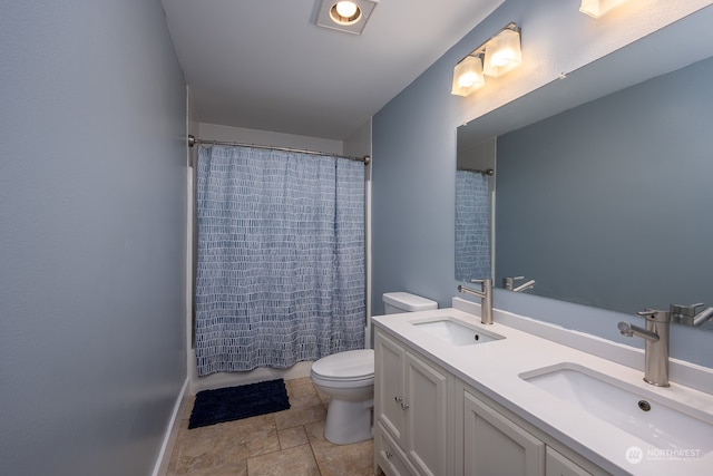 full bathroom with vanity, shower / bath combo, and toilet