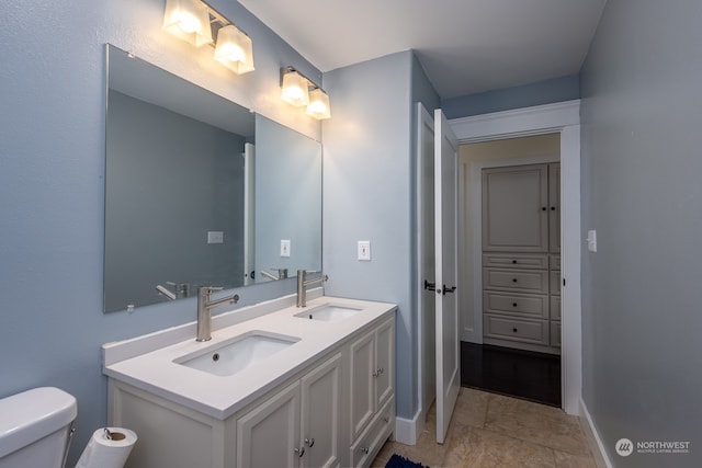 bathroom featuring vanity and toilet