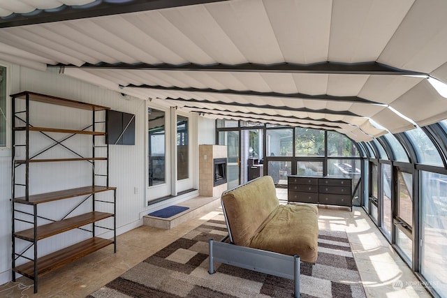 sunroom / solarium featuring vaulted ceiling and a wealth of natural light