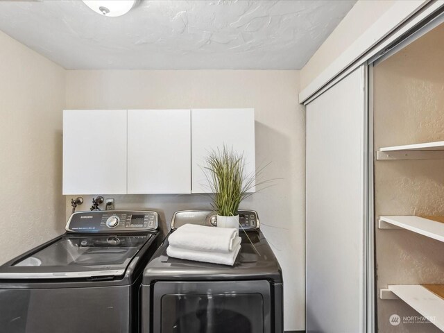 laundry area with cabinet space and washing machine and clothes dryer