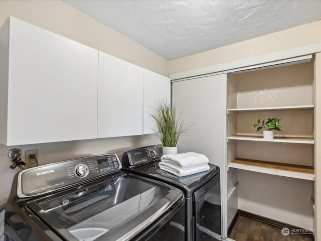 clothes washing area featuring a textured ceiling, cabinets, washer and dryer, and dark hardwood / wood-style floors