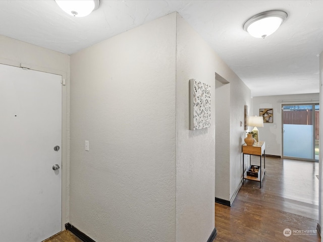 corridor with dark hardwood / wood-style floors