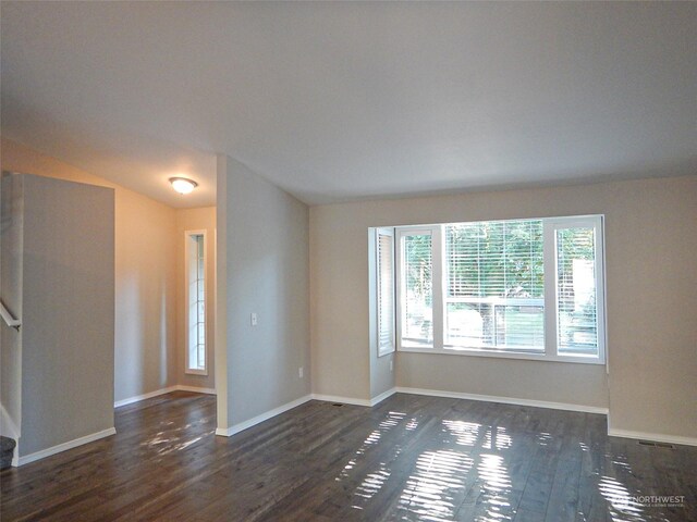 spare room with dark hardwood / wood-style flooring