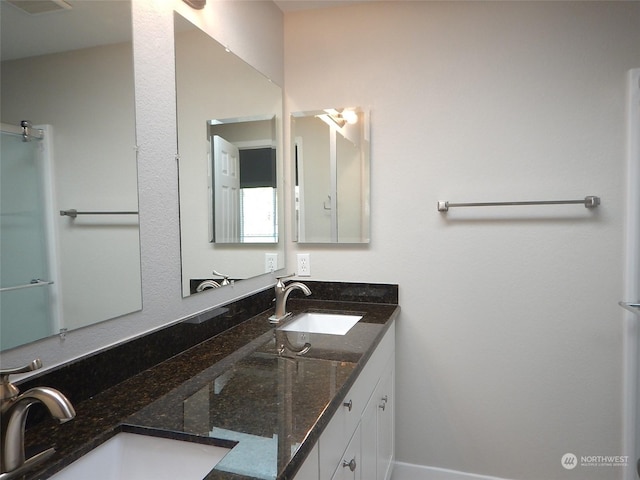 full bath with double vanity and a sink