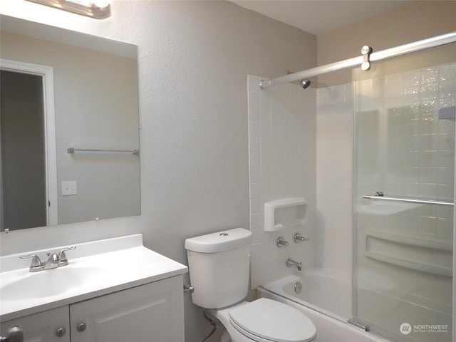 bathroom featuring enclosed tub / shower combo, vanity, and toilet