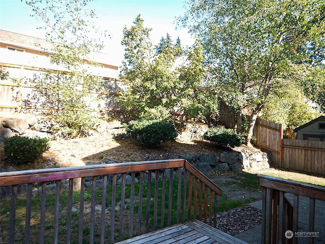 wooden terrace featuring a fenced backyard