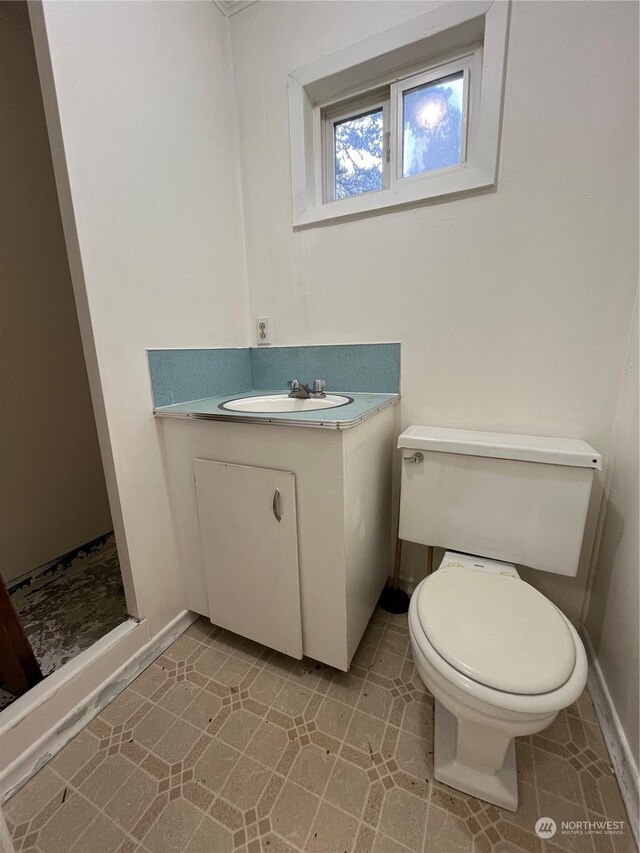 bathroom with tile patterned floors, toilet, and vanity