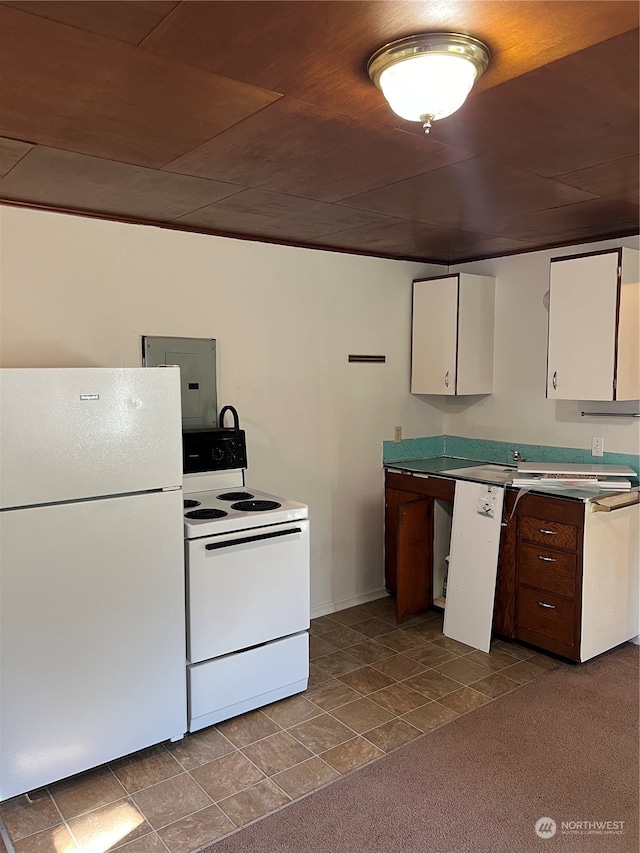 kitchen featuring white appliances, carpet, white cabinets, and electric panel