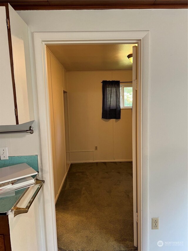 hallway with dark carpet