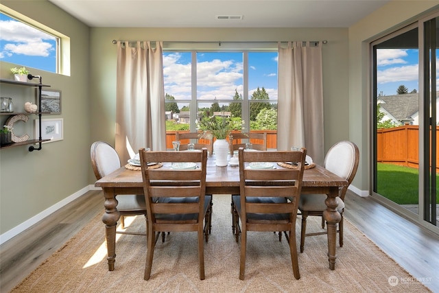 dining space with light hardwood / wood-style floors