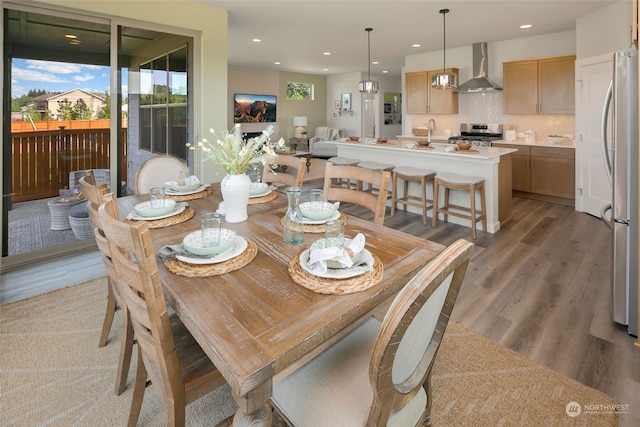 dining area featuring sink and hardwood / wood-style floors