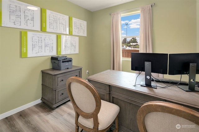 home office with light hardwood / wood-style floors