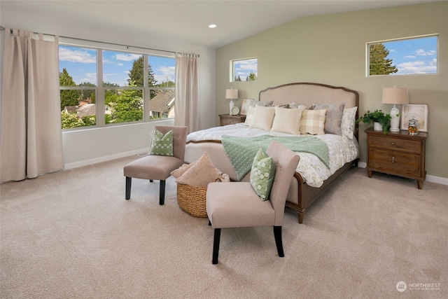 bedroom with light colored carpet and vaulted ceiling