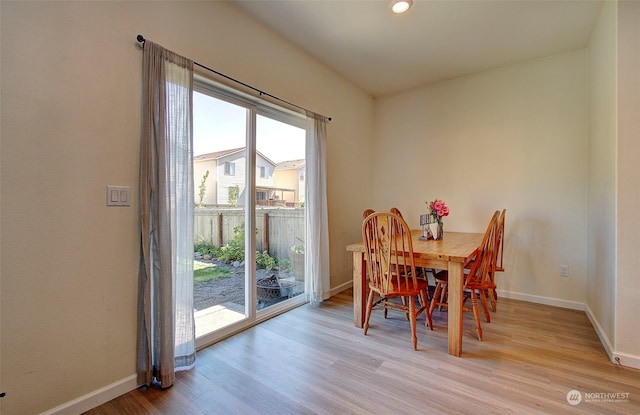 dining space with light hardwood / wood-style flooring