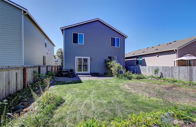 rear view of property with a yard