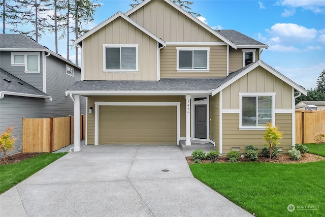 view of front of home with a garage and a front lawn