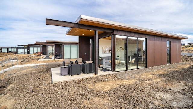 back of property featuring outdoor lounge area