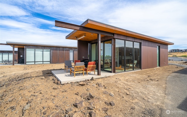 rear view of property featuring a patio